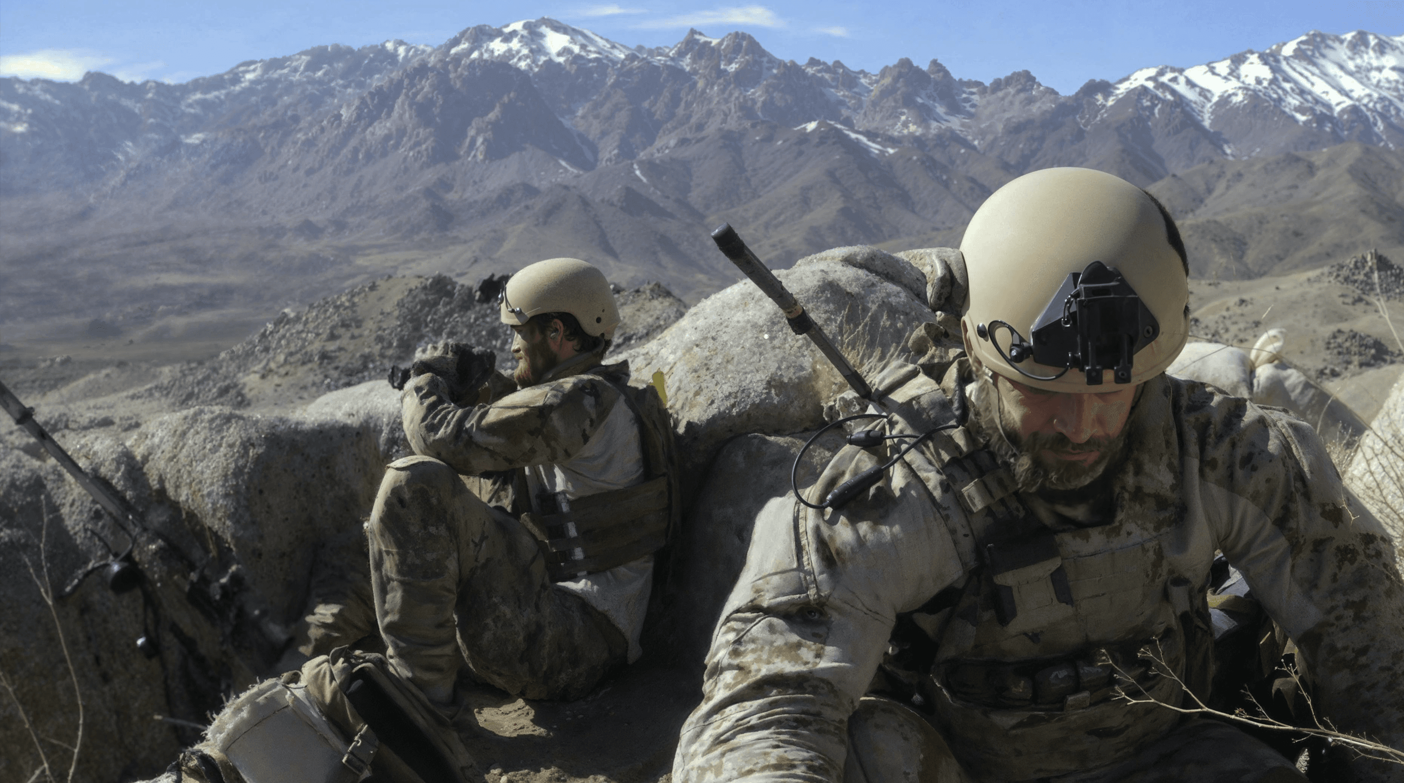 Mountain operators conducting overwatch with rugged equipment